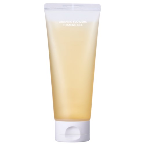 En beige tube merket 'Organic Flowers Foaming Gel' står oppreist med hvit lokk, sannsynligvis et hudpleie- eller skjønnhetsprodukt.