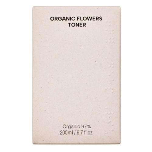 En beige boksamp med merket 'Organic Flowers Toner' med noen små, synlige prägeprikker på høyre side.