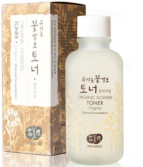 Valkoinen pullo, jossa lukee 'Organic Flowers Toner' ja ruskea-kulta kukkainen laatikko sen vieressä.