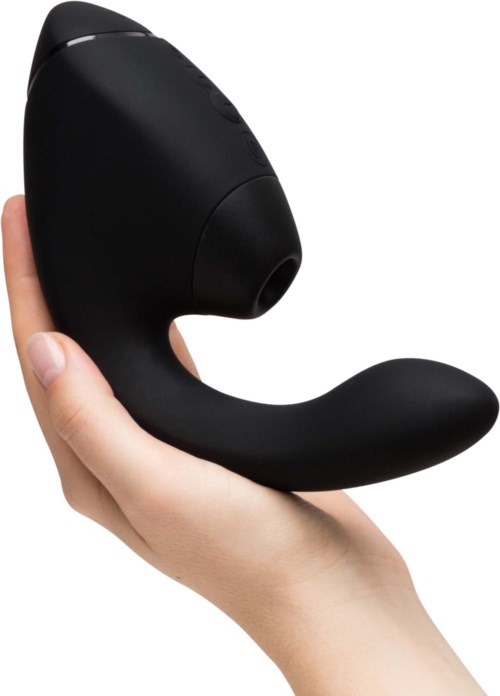 Eine Hand hält ein schwarzes persönliches Massagegerät mit gebogener Form und runder Spitze.