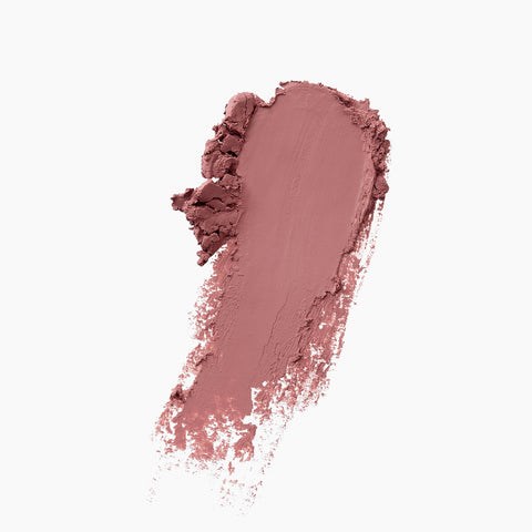 Een roze make-up of lipstick-strook op een witte achtergrond, die textuur en kleur toont.