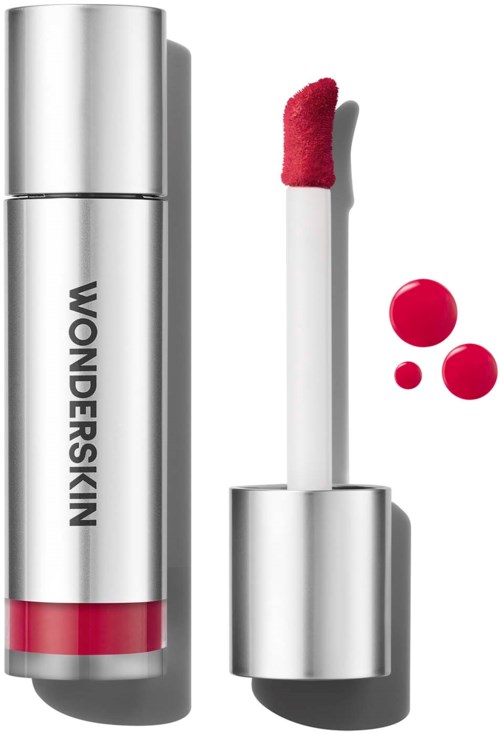 Lip gloss tube with pink lip gloss and small pink and red dots next to it.
