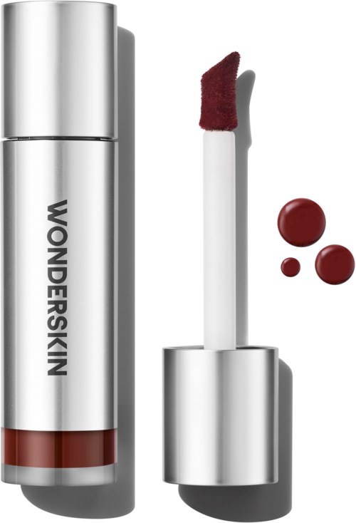 Lip gloss applicator with red gloss and three red gel blobs beside it. Silver tube with the brand name Wonderskin.
