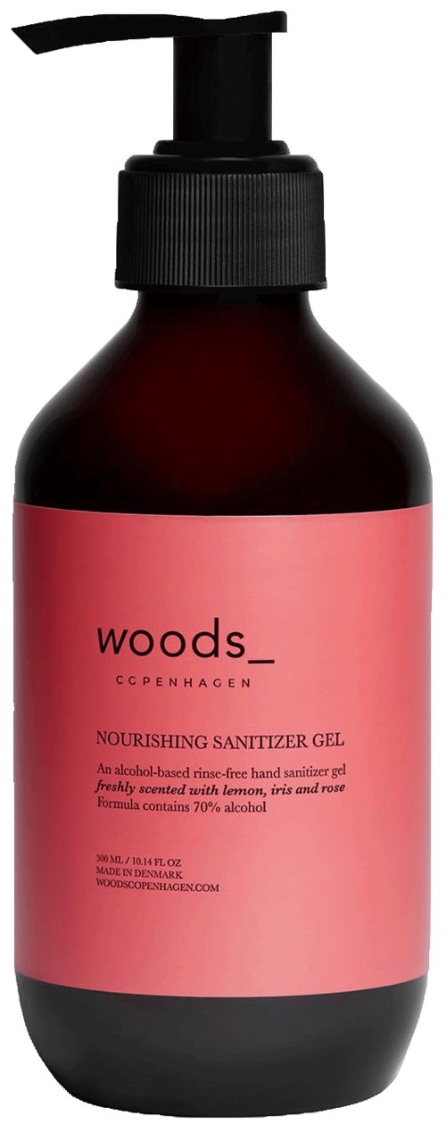 En brun flaska med en svart pump och en rosa etikett för näringsgivande handspritgel.