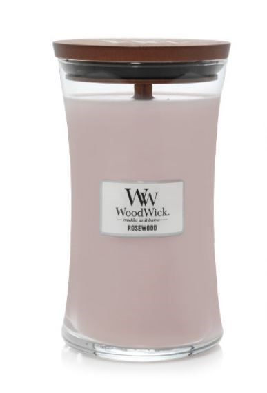 A pink scented candle in a clear glass jar with a wooden lid and a label that says 'WoodWick' and 'Rosewood.'