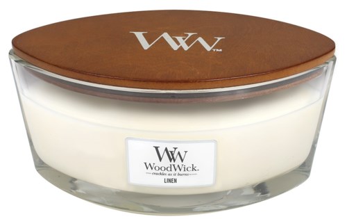 Ett tändljus i glasburk med ett trädopp och etiketten 'WoodWick Linen'.