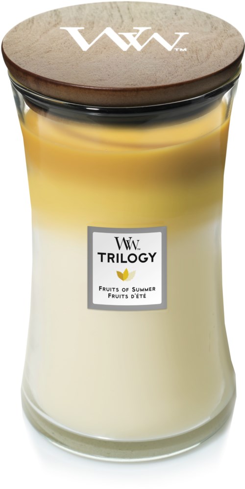 A large candle in a glass jar with a wooden lid, labeled "Trilogy Fruits of Summer."