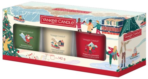 Låda med tre Yankee Candle juldoftande ljus, dekorerad med jultema och vinterscener.