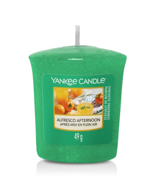 Green candle with a label showing fruits, named Alfresco Afternoon, 49 grams.