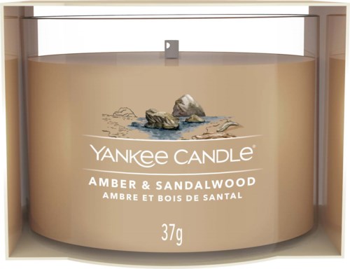 En Yankee Candle behållare med doft av bärnsten och sandelträ, med stenar och vatten, väger 37 gram.