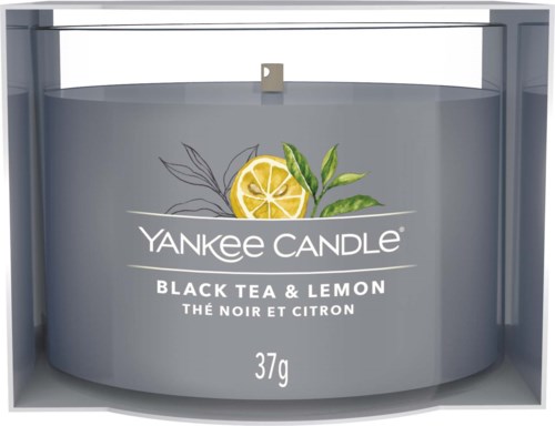 A Yankee Candle is shown with a black tea and lemon scent, featuring lemon slices and green leaves on the label.