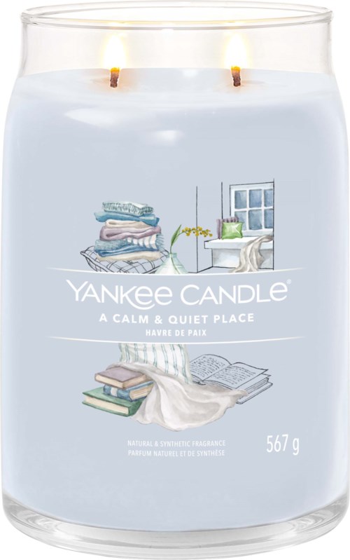 Eine hellblaue Yankee Candle mit einer ruhigen, gemütlichen Zimmerillustration und zwei flackernden Kerzen oben.
