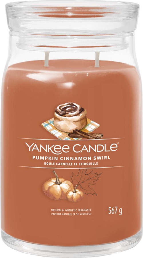 A large glass jar candle with pumpkin and cinnamon swirl scent label, 567 grams, in soft orange color.