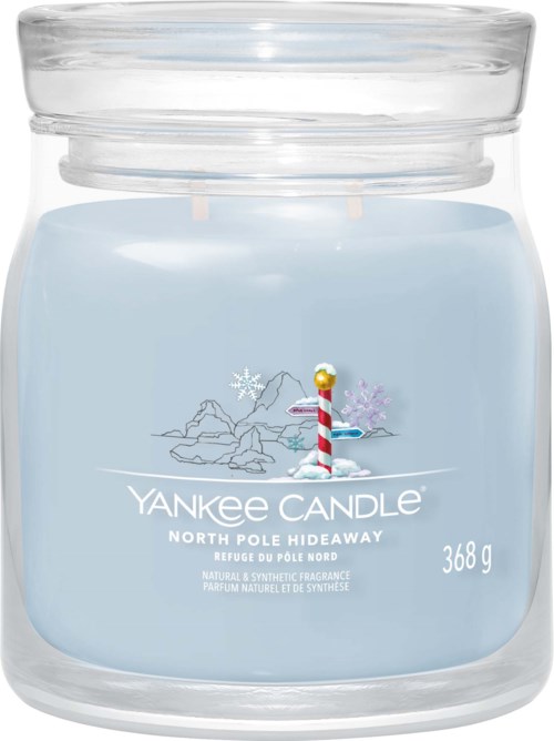 A light blue Yankee Candle jar with a winter scene and a small striped candle illustration.