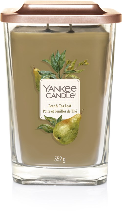 Stort doftljus i ett glas med ett ljusbrunt lock, märkt 'Yankee Candle Pear & Tea Leaf.'.