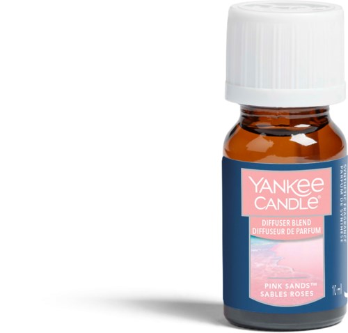 En liten brun flaske med hvit hette og rosa etikett, merket 'Yankee Candle Pink Sands' duft.