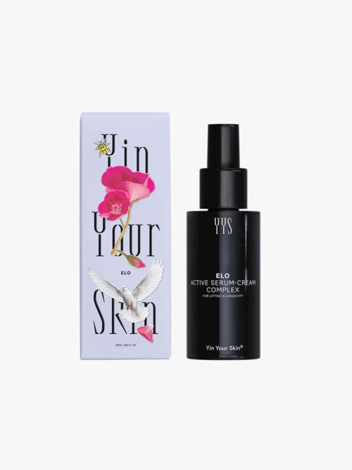 A black spray bottle of YUS Elo Active Serum Cream and purple, pink, and white box with flowers and a bird design.
