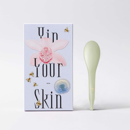 A box with the words "Unlour Skin" and flowers, and a light green facial massager device beside it.