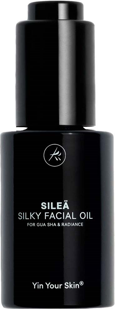 A black bottle of SILEÄ Silky Facial Oil for skin glow and radiance with simple white text.