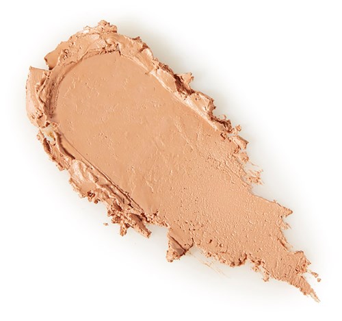 A beige makeup foundation swatch with rough, uneven edges on a plain white background.