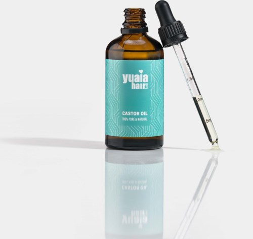 En brunt flaska märkt "Yuaia Hair Castor Oil" med en pipett bredvid.