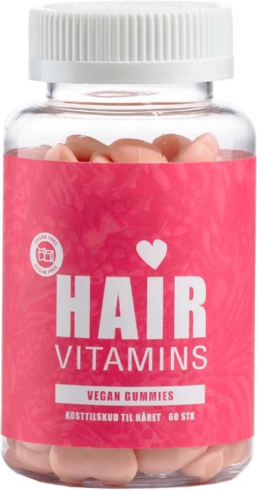 Vegan hair vitamins in pink container, with a white cap, showing gummy supplements inside.
