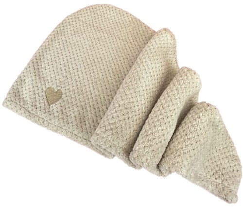 Ein gemütlicher cremefarbener Strickhut mit kleinem Herz am Rand.