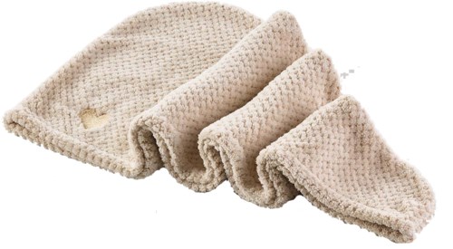 Fyra mjuka, beige, stickade tvättlappar eller handdukar ihoprullade.