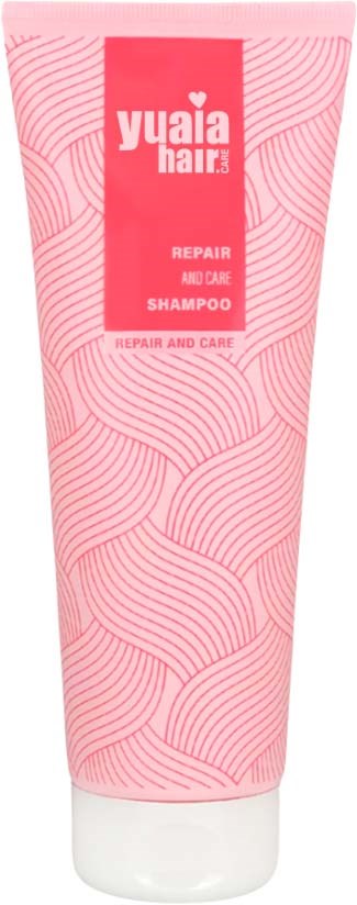 Lyserødt shampoo rør med bølgede linjer, logo og tekst for reparation og pleje i hårpleje.