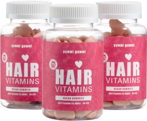 Tre flasker veganske hårvitamintuggumi med rosa etiketter og hvite lokk.