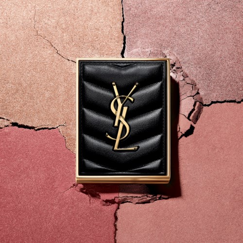 A YSL logo on a black leather box, on a cracked, multicolored background.
