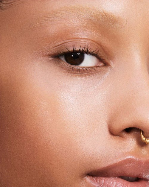 Close-up of a person's eye and part of their face, showing smooth skin and natural makeup.