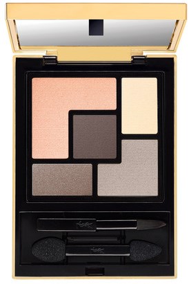 A makeup palette with four different shades of eyeshadow in peach, dark gray, light beige, and taupe, with small applicators.