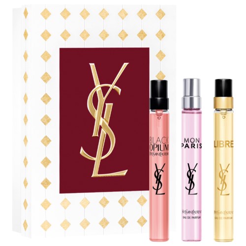 Vertikal Yves Saint Laurent-logo med tre parfymeflasker i rosa, lilla og gull foran.