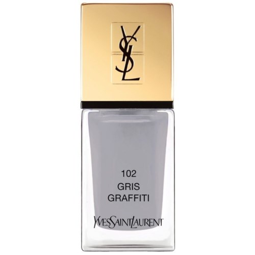En flaske YSL neglelakk i grå graffiti farge med gullhette og YSL-logo.