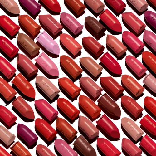 A colorful display of various lipstick shades arranged in neat rows.