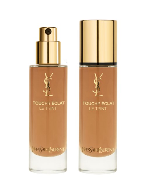 Två flaskor av Yves Saint Laurent makeup grundfärg med guldkorkar och beige vätska inuti.