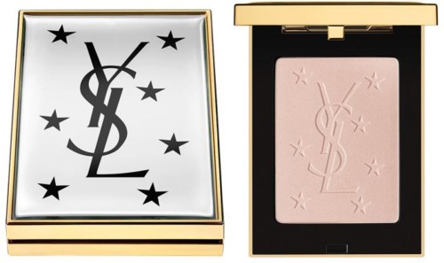 Ett sminkpaket med en ljus puder och ett fodral dekorerat med svart YSL-logotyp och stjärnor.