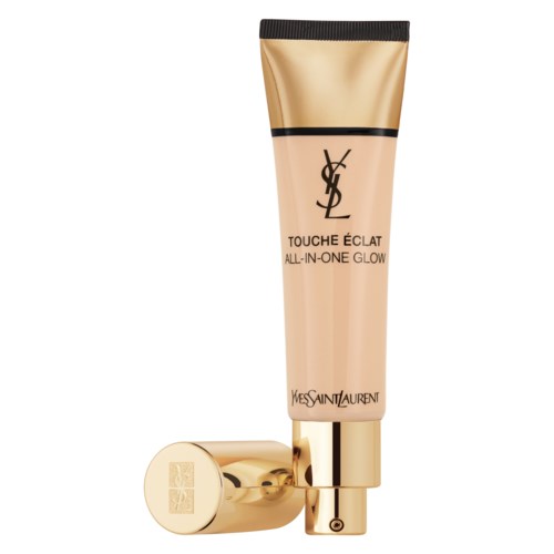 Puszka Yves Saint Laurent glow makijażu w kolorze beżowym i złotym z czarnym zakrętkami i logo.