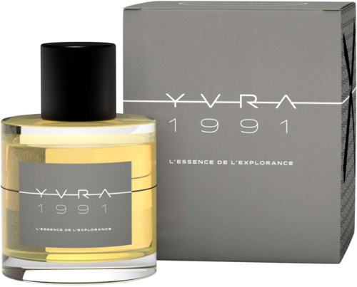 A perfume bottle and box labeled 'YVRA 1991 L'ESSENCE DE L'EXPLORANCE' with a black cap and grey packaging.