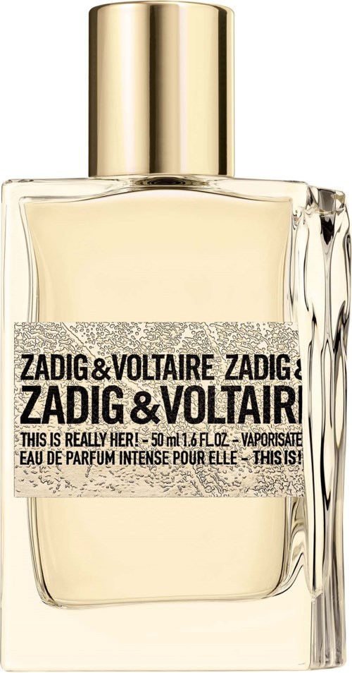 En parfymflaska med guldkapsel, klart glas och en etikett som upprepar 'ZADIG & VOLTAIRE' i svart text.