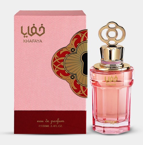 A pink perfume bottle with gold and pink details, next to a matching pink box with patterned design.