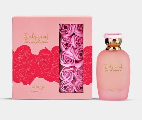 A pink perfume bottle with gold accents and a pink lid, beside a pink box with roses design and gold text.