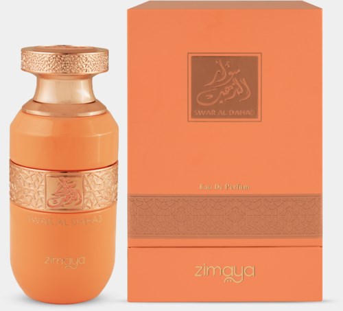 A perfume bottle with a golden cap and a peach-colored box, featuring gold accents and Arabic script.